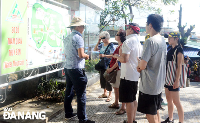 Tour guides are regarded as ‘tourism ambassadors’ for the city. Here is a tour guide on duty at the Marble Mountains Tourist Area