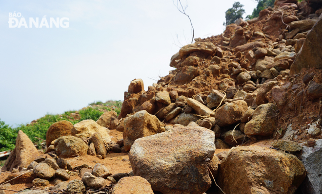 A volume of soil and stones have spilled out onto a road leading to the Son Tra Peninsula