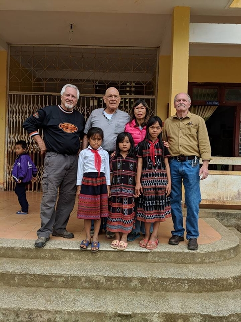 Clark (second from left) and his wife (third from left) poses with their friends and ethnic children during a charity programme. — Photo Mark Oconnor Facebook