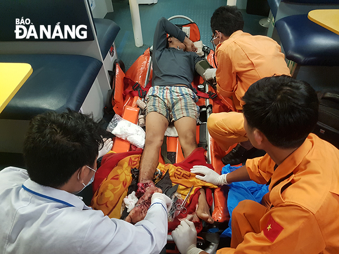 Doctors giving initial first aid to the injured fisherman