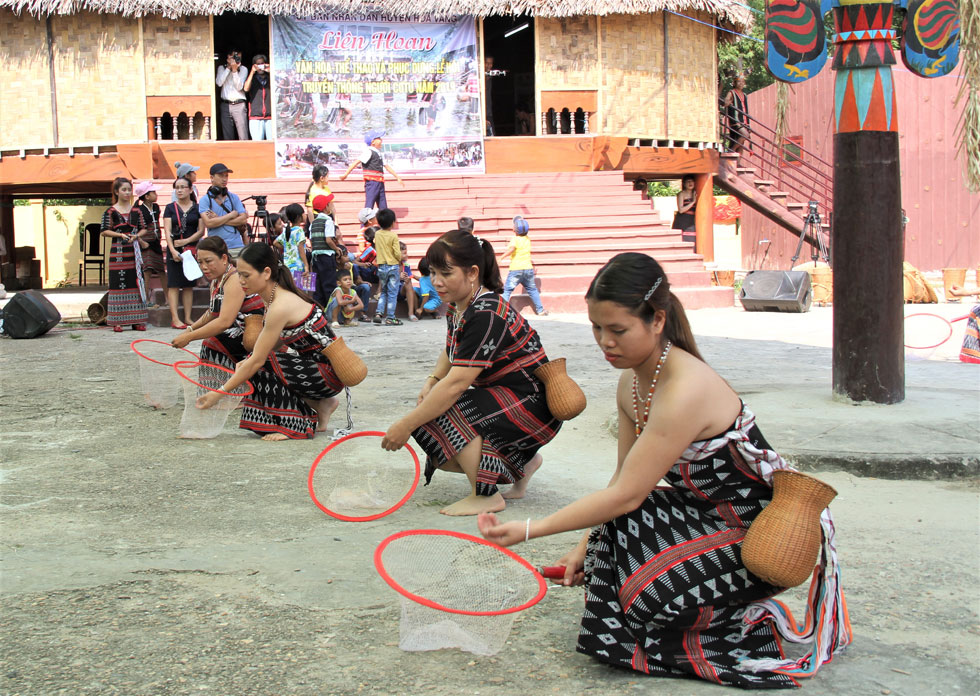 Co Tu women performing a fish catching dance, and …