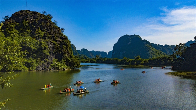 Visitors enjoy the beauty of Trang An tourism site in the northern province of Ninh Binh