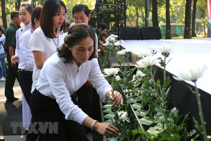 Đông đảo nhân dân Thành phố Hồ Chí Minh đặt hoa tưởng niệm các nạn nhân tử vong do tai nạn giao thông. (Ảnh: Thanh Vũ/TTXVN)