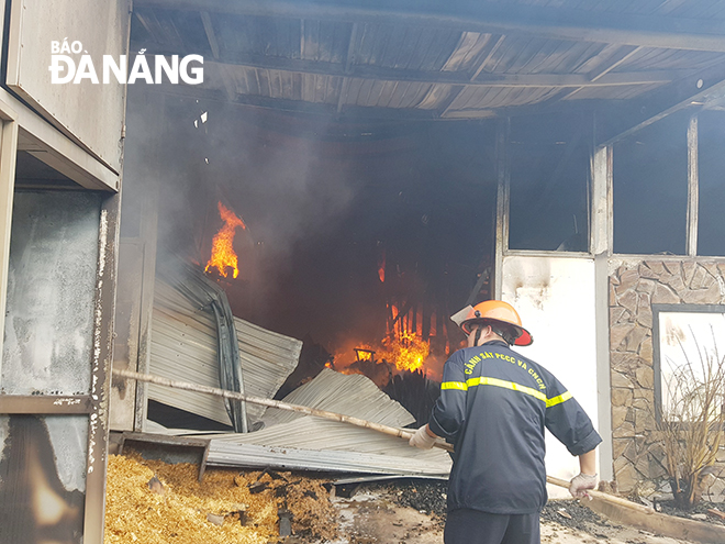 A firefighter trying put off the fire