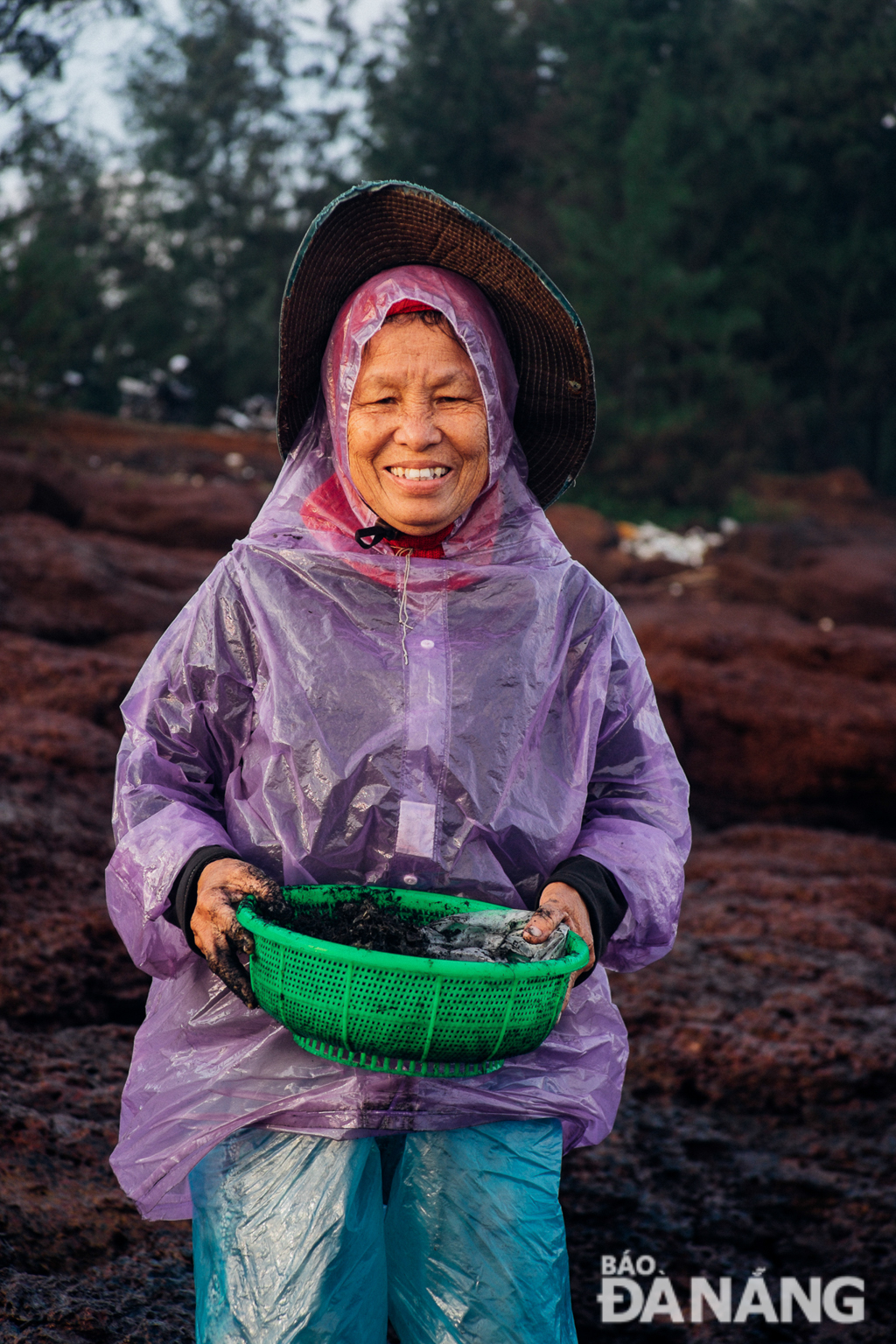 A female harvester is happy with a basket full of seaweed