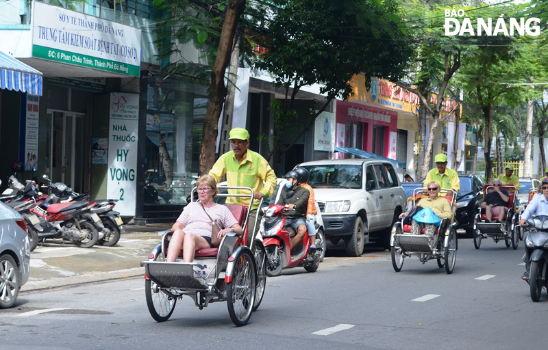 Foreign visitors enjoying a city tour by cyclo