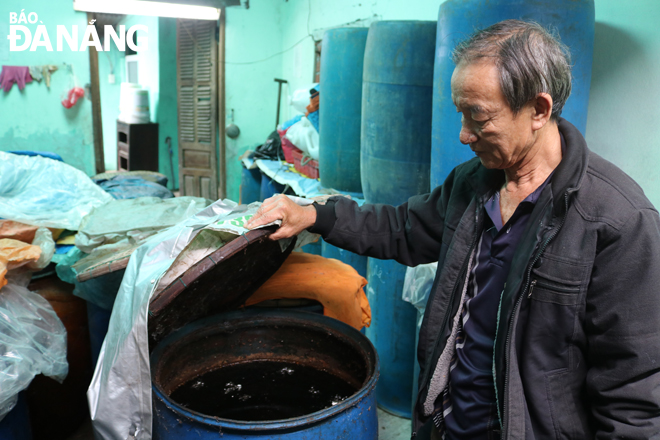 The Chairman of the Nam O Fish Sauce Association cum Deputy Director of Dong Hai Cooperative, Mr Tran Ngoc Vinh, checking fermentation process of ‘ fish sauce’ before making a liquid containing fish extract