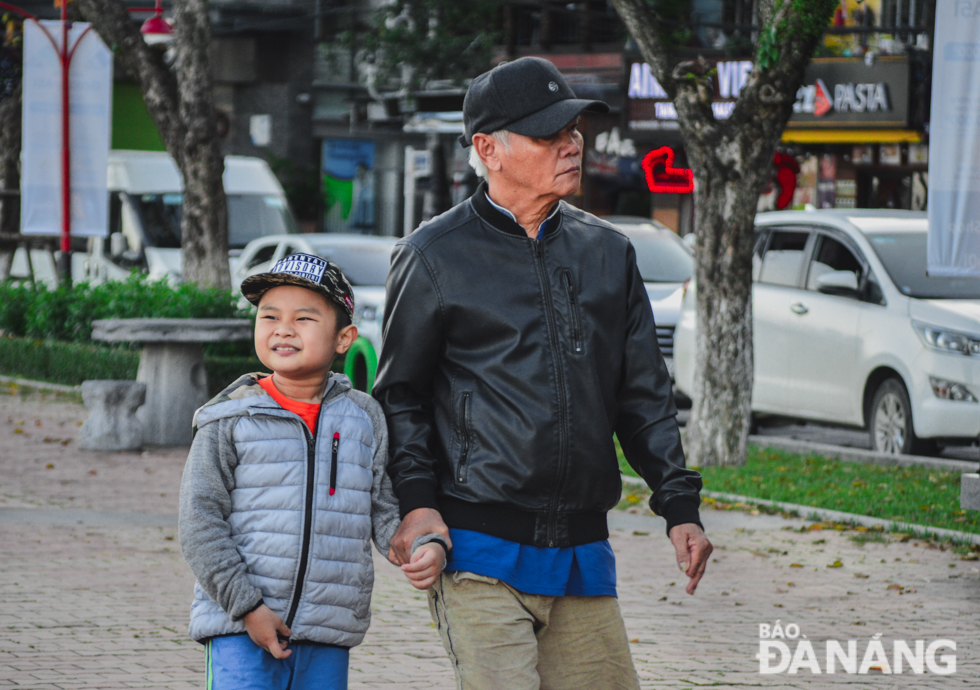 A young boy is taken to the city centre by his grandfather