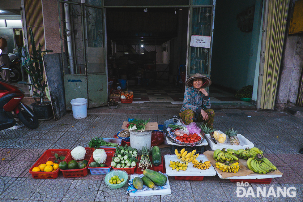 A small trader selling vegetables and fruits on the pavements of a local street