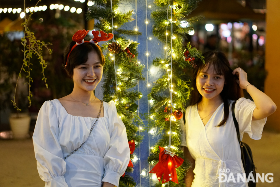 Young girls posing for a photo to save their memorable Christmas moments