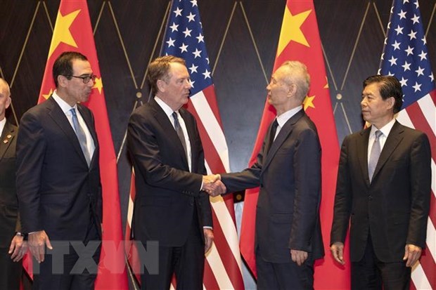 U.S. Treasury Secretary Steven T. Mnuchin shakes hands with Chinese Minister of Commerce Zhong Shan in Shanghai in July. (Photo: AFP/VNA)