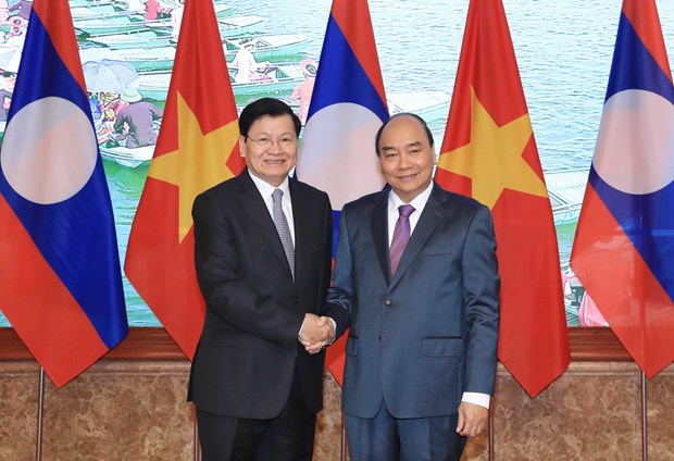 Prime Minister Nguyen Xuan Phuc (R) and Lao Prime Minister Thongloun Sisoulith. (Photo: VNA) 