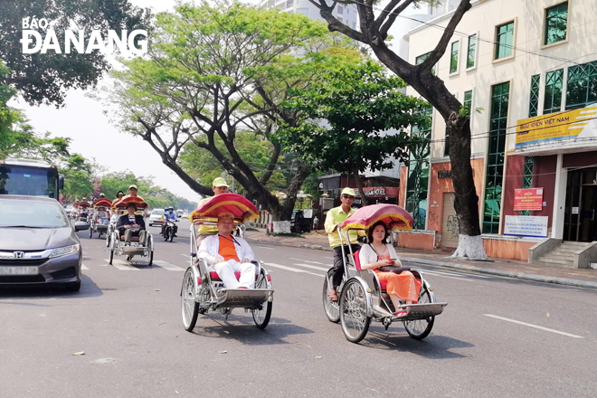 Foreign visitors enjoying a city tour by cyclo