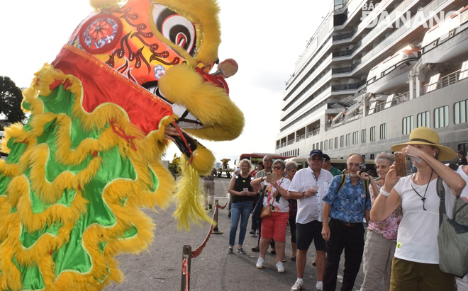 A lion dance performance to welcome the first cruise ship passengers to set foot in the city