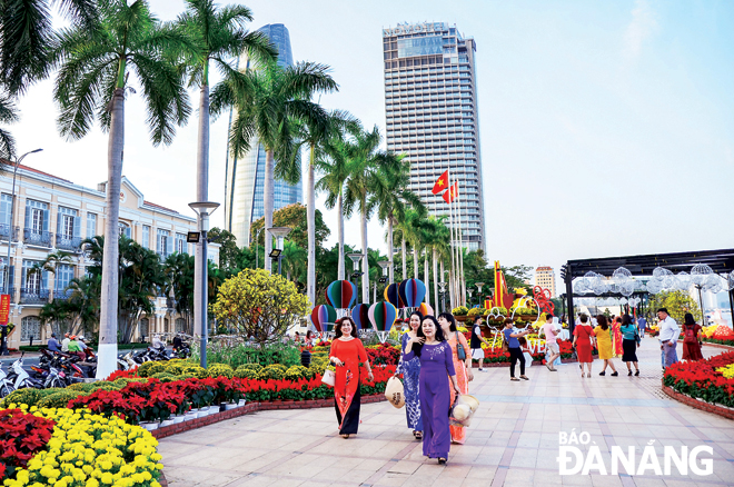 Local residents going for a stroll on the pavements of Bach Dang Street