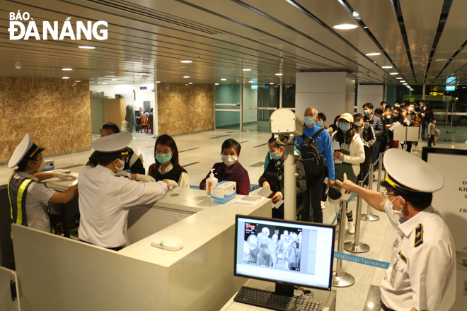 Tourists queueing up for body temperature measurement and entry procedure handling at Da Nang International Airport