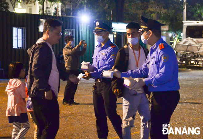 Visitors to this site receiving free face masks from representatives from the municipal Department of Health, and the Department of Transport