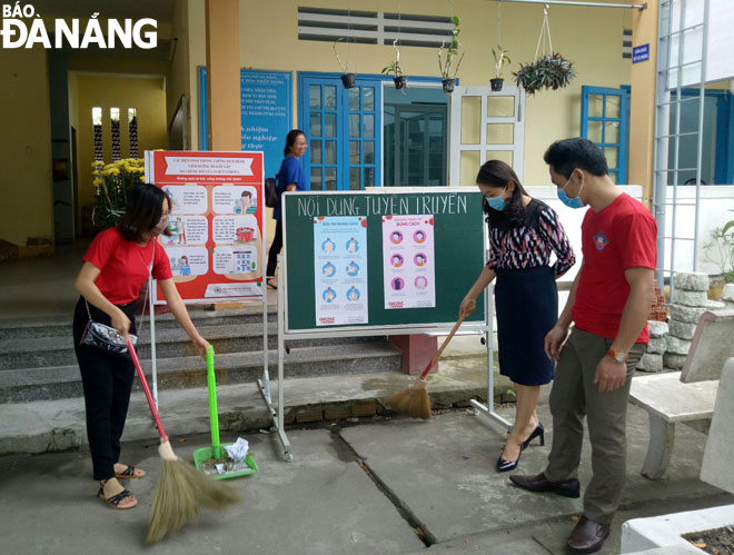 Teachers of the Ton That Tung Senior High School cleaning up the school during their off-school time