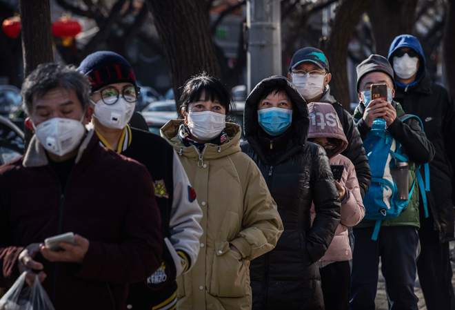 Người dân Trung Quốc mang khẩu trang xếp hàng trước một cửa hàng ở thủ đô Bắc Kinh. 		Ảnh: Getty Images