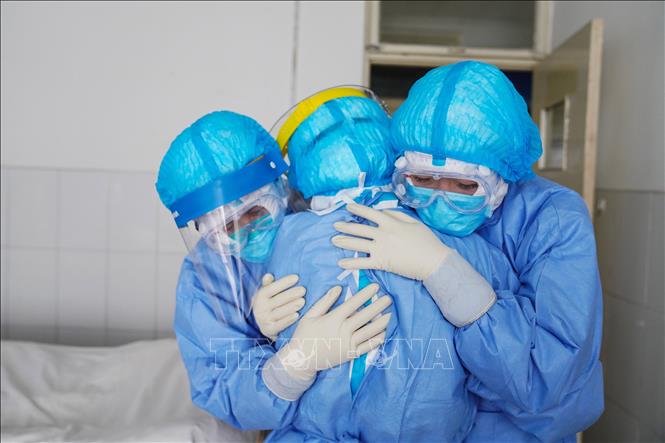 Nhân viên y tế động viên lẫn nhau trước khi vào khu vực cách ly để điều trị cho bệnh nhân nhiễm virus Corona chủng mới tại Sơn Đông, Trung Quốc ngày 28-1-2020. Ảnh: AFP/TTXVN