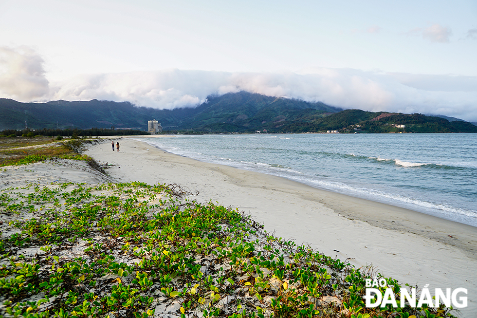 Strips of white cumulus clouds covering the Hai Van Pass seen from the Nam O Beach in Lien Chieu District