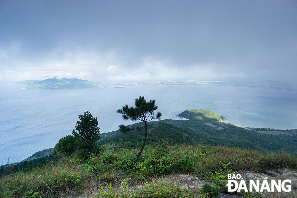 The Son Tra Peninsula and Da Nang are seen in the clouds from the Hai Van Gate.