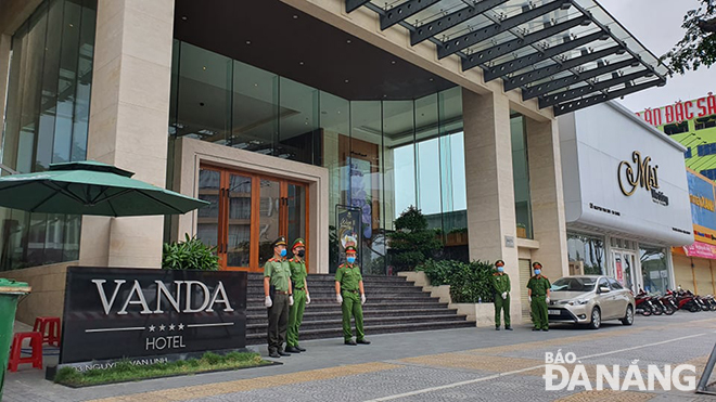 Local police officers being on duty around the clock in front of the Vanda Hotel