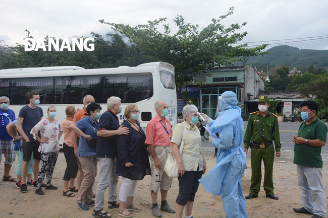 Foreigners are required have their temperature checked at a checkpoint at the southern end of the Hai Van Tunnel