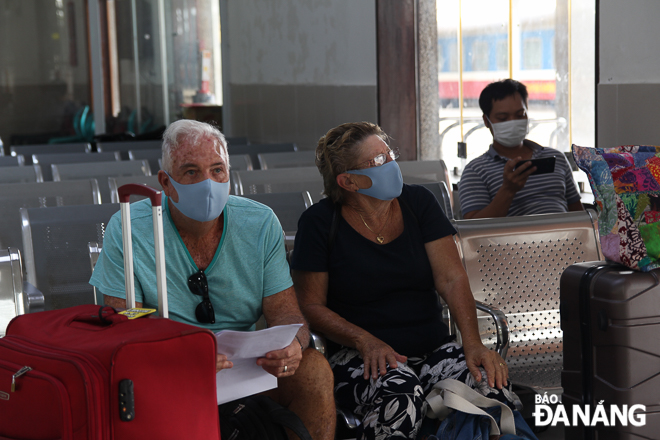 Foreigners wearing face masks at the Railway Station