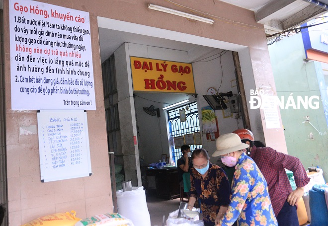 A whiteboard at Mrs Hong’s rice selling store advising shoppers to stop panic buying and hoarding