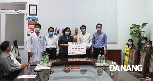 Representatives from the municipal Department of Health receiving one billion VND in cash from the AHT company