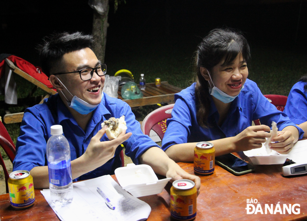 Student volunteers eating dumplings in their night shift