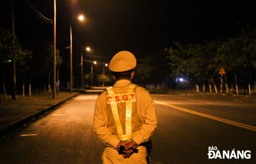 A traffic police officer in his night shift at the southern gateway of the Hai Van Tunnel