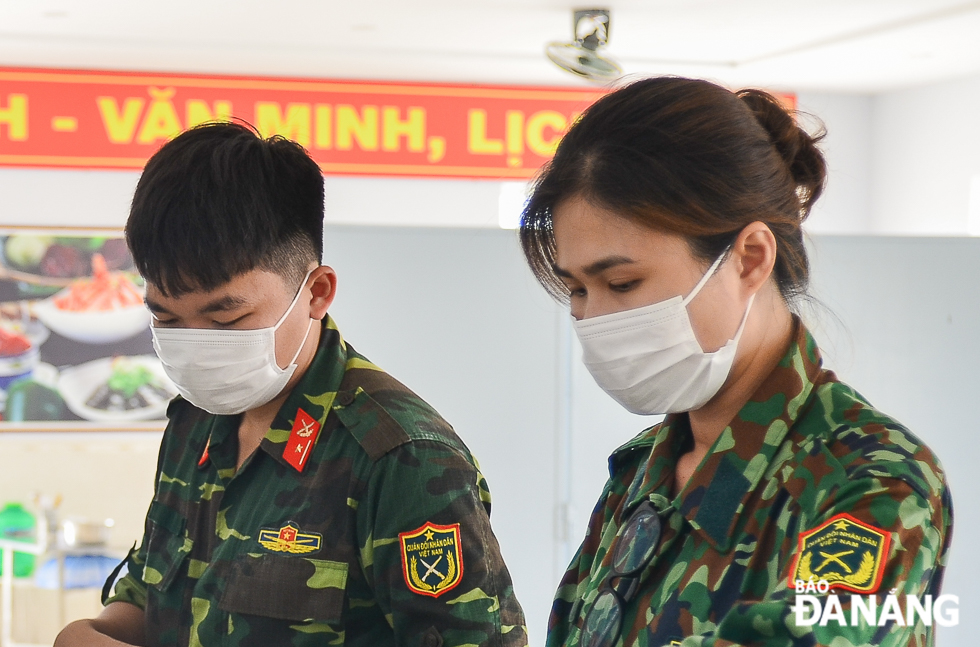 Military personnel wearing face masks at work. 