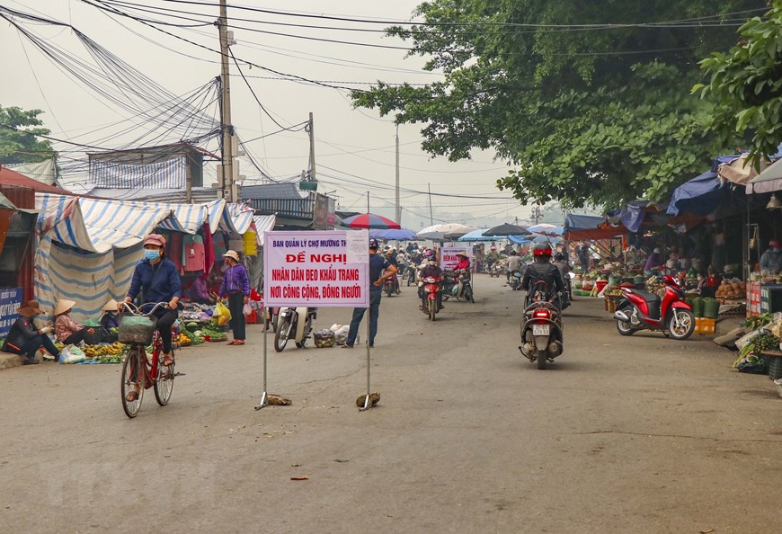 Ban quản lý Chợ Mường Thanh, Điện Biên, đặt biển đề nghị người dân đeo khẩu trang. (Ảnh: Xuân Tư/TTXVN)