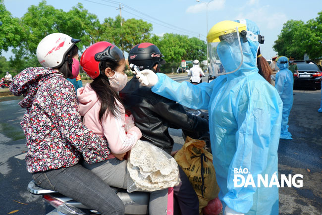 Thousands of arrivals to the city have their temperature taken at checkpoints every day