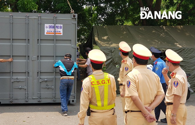 Shipping containers being placed at checkpoints 