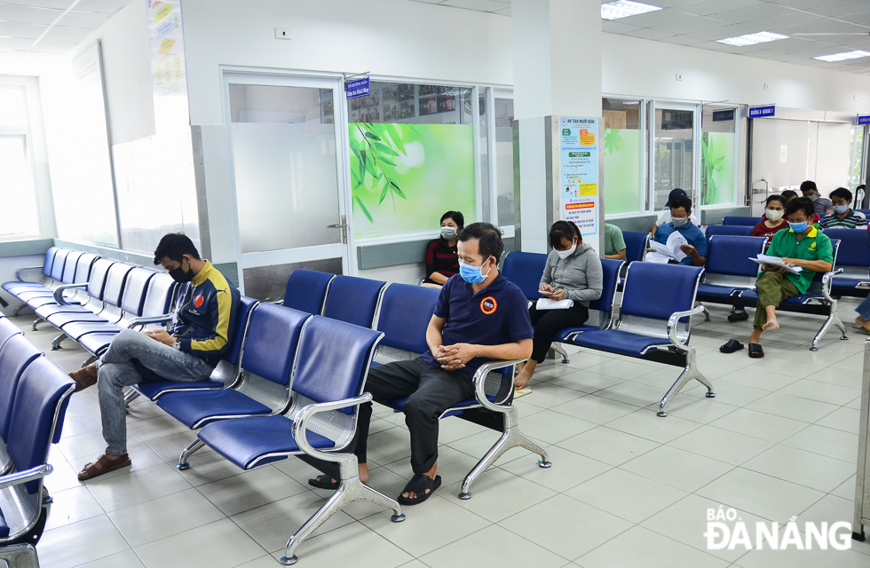 Visitors are required to keep space around each other at the healthcare waiting area in the hospital