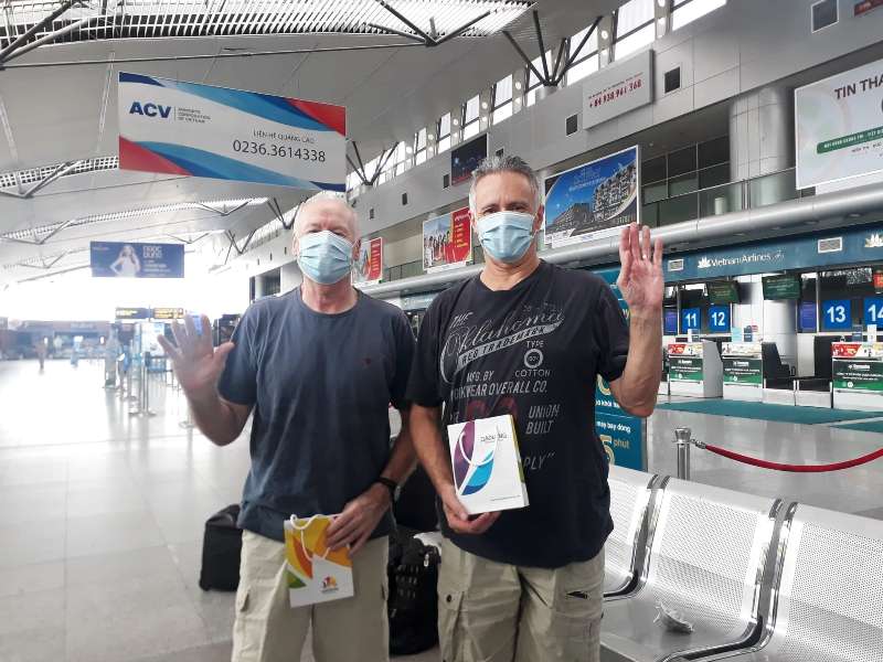 The two British men waving goodbye to Da Nang before flying to their home