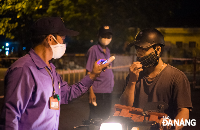 Motorbike drivers are required to wear face masks and have their temperature checked at the entrance gate