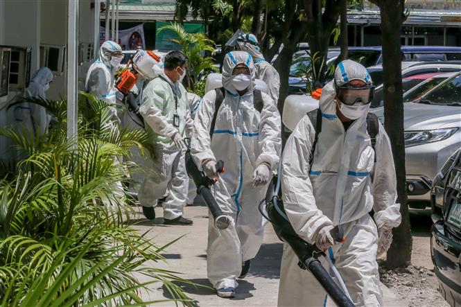  Công nhân phun thuốc khử trùng nhằm ngăn dịch COVID-19 lây lan tại Manila, Philippines ngày 7/4/2020. Ảnh: THX/TTXVN