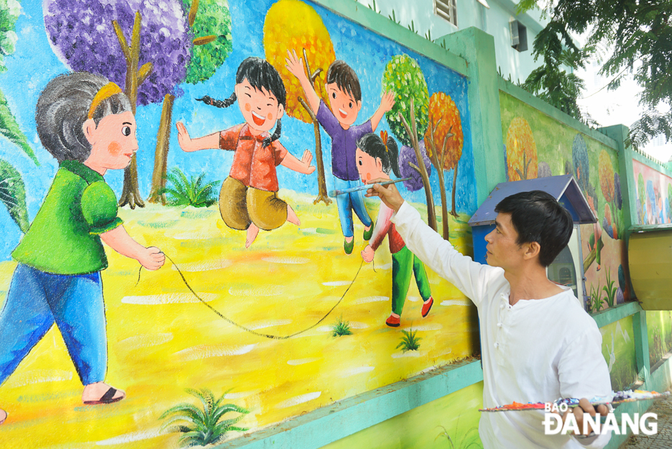 As his school is closed due to the coronavirus pandemic, Mr Thanh still goes to the school everyday for painting murals