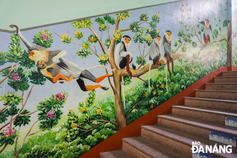 A wall painting featuring red-shanked douc langurs at a staircase in the school