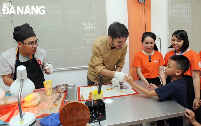 Victor Ceano Savall (second, left), the founder of the Pop Keo, instructing kids to make candies in late 2019.