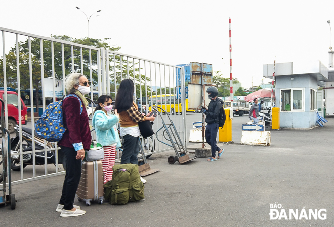 Some passengers waiting in front of the coach station