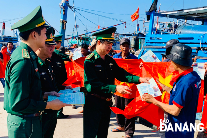 Bộ đội Biên phòng thành phố tặng cờ Tổ quốc và ảnh Bác Hồ cho ngư dân quận Sơn Trà trong tháng 10-2019, đồng hành cùng ngư dân bám biển.           		               Ảnh: KIM NGÂN