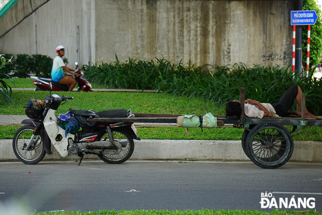 A casual worker taking a rest under the Hue T-junction overpass