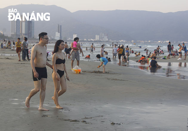 A young couple walking on the beach