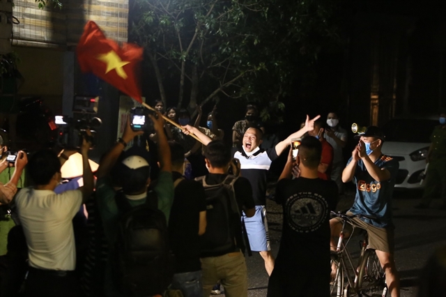 Dong Cuu villagers celebrate as the lockdown order is lifted on Thursday morning