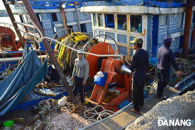 Crewmembers onboard fishing boat QNg-97767 from Quang Ngai Province ready for heading out to sea.